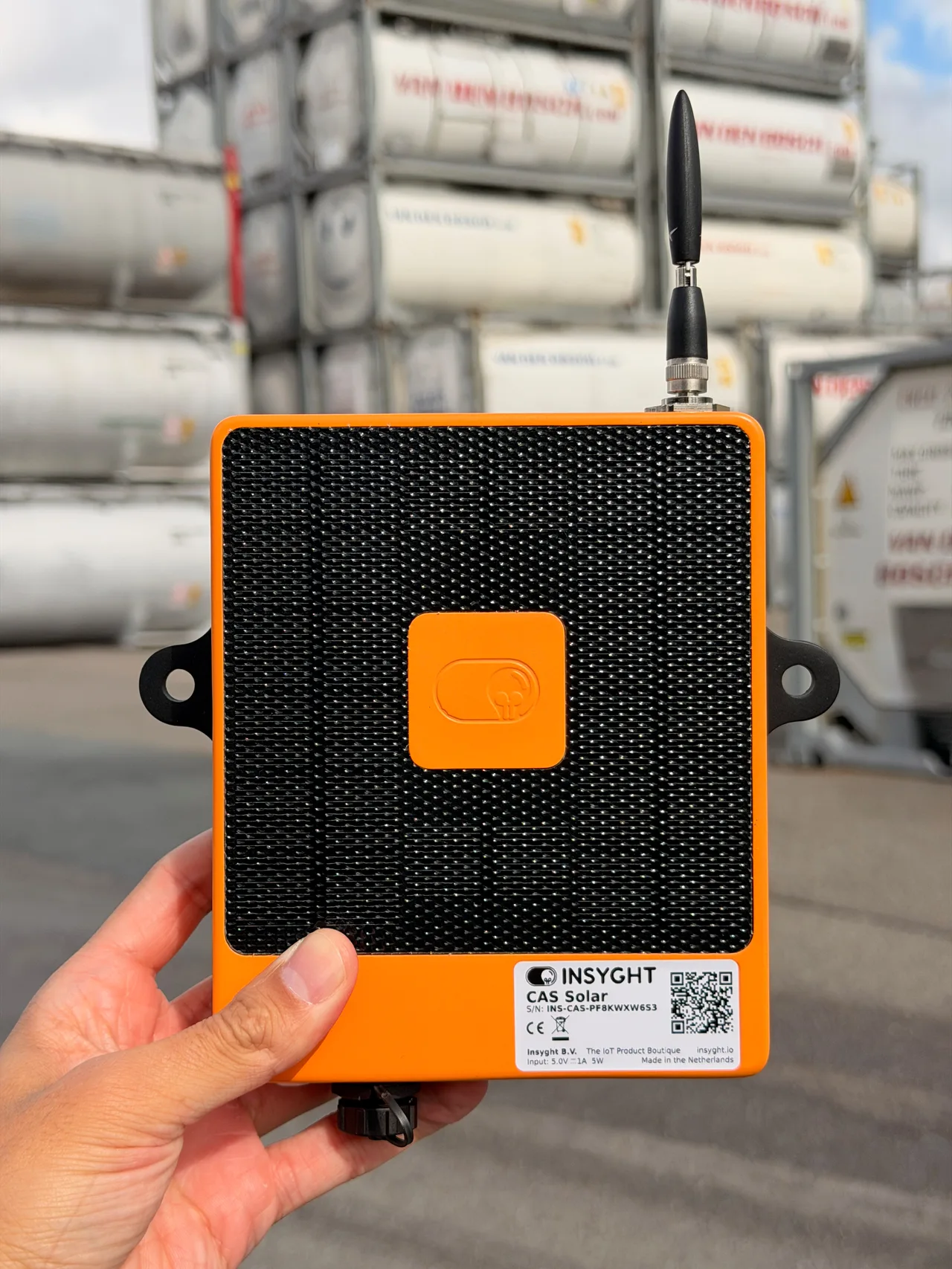 CAS Solar held in front of tank containers in an outdoor storage yard